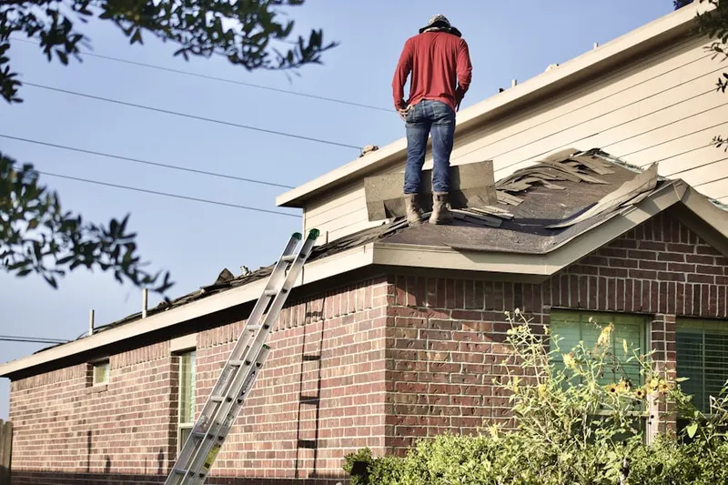 Professional roofer working on a residential roof in West Pen Argyl